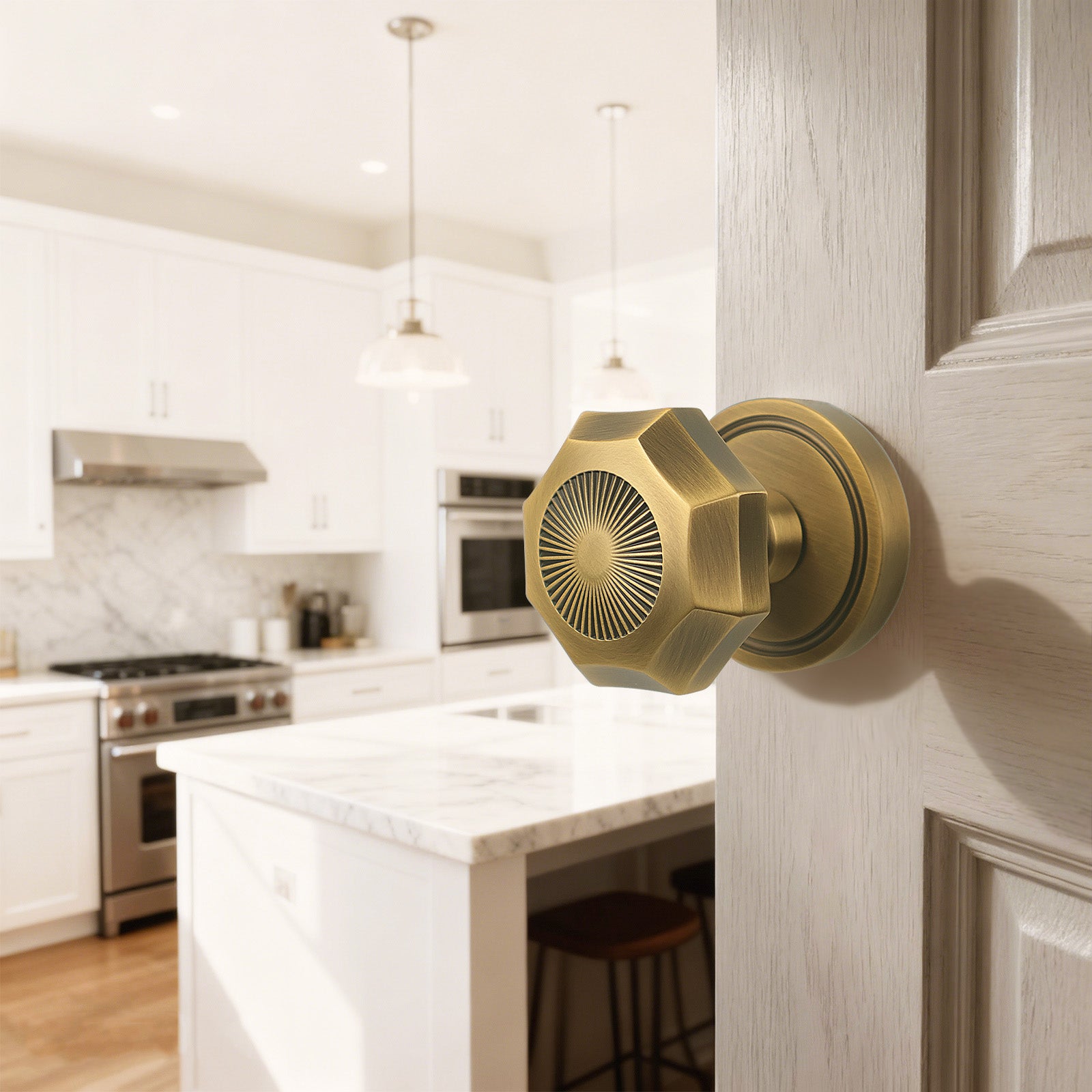 Antique brass octagonal sunburst passage door handle mounted on interior door with bright kitchen background