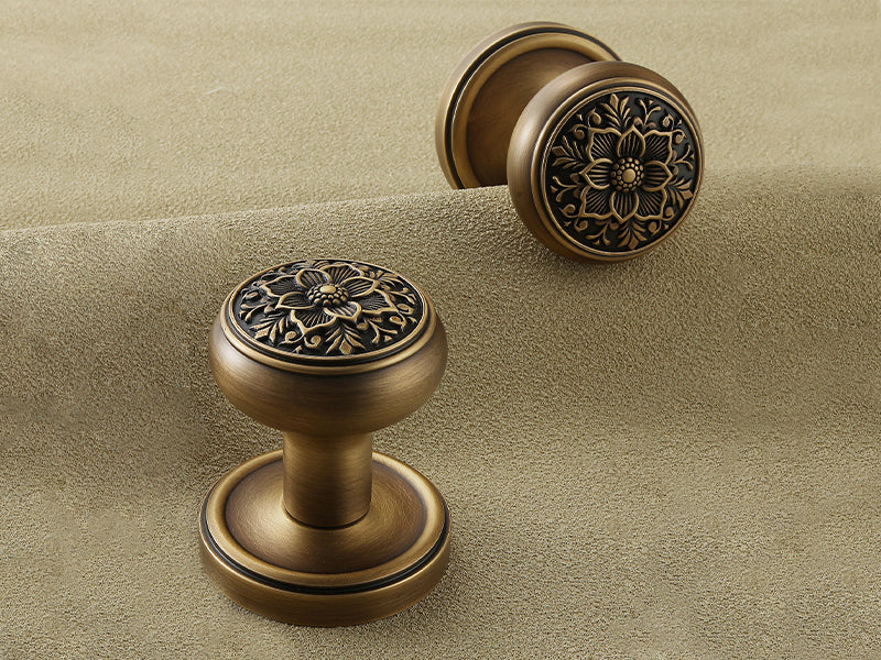 Pair of antique brass floral dummy door knobs with vintage engraved floral motif