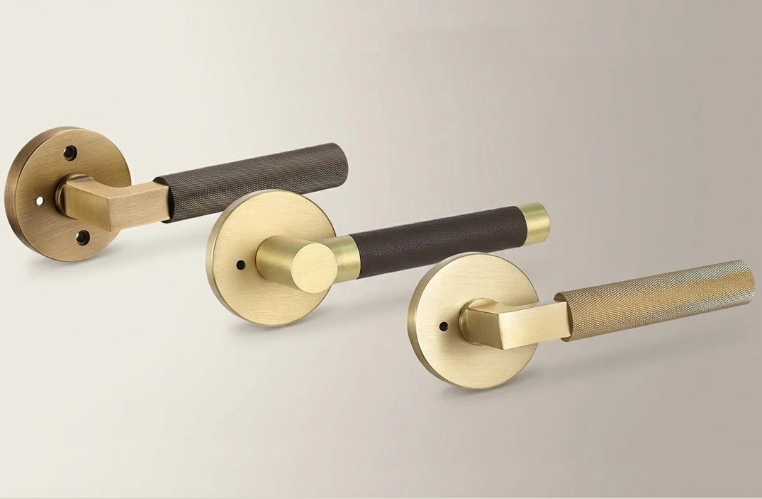 Modern knurled and leather-wrapped brass door lever handles with round rosettes